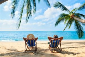 Couple relax on the beach enjoy beautiful sea on the tropical island. Summer beach vacation